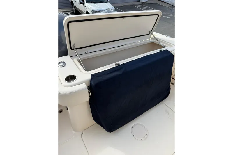  Yacht Photos Pics Open storage compartment on 2019 Grady-White Canyon 306 boat, featuring a navy cover.
