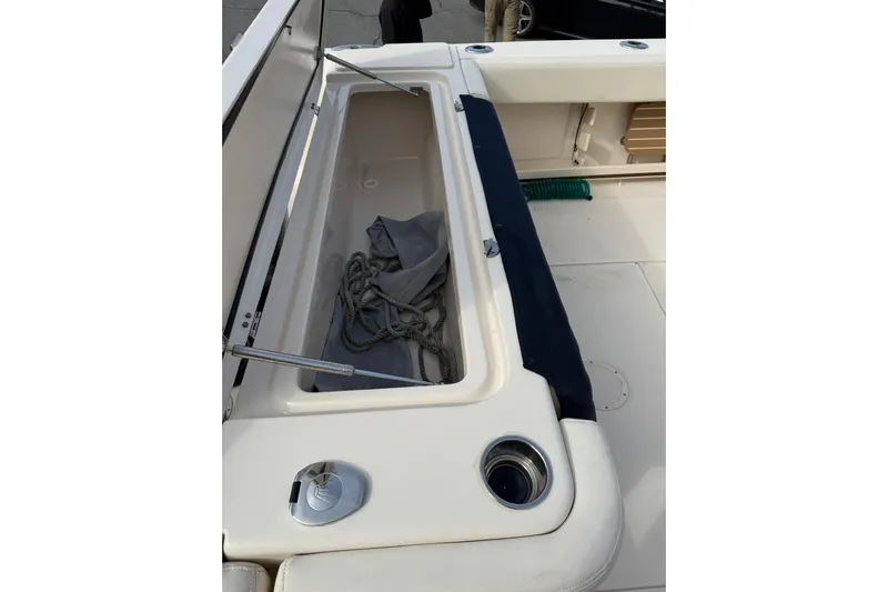  Yacht Photos Pics 2019 Grady-White Canyon 306 boat storage compartment with rope and cover.