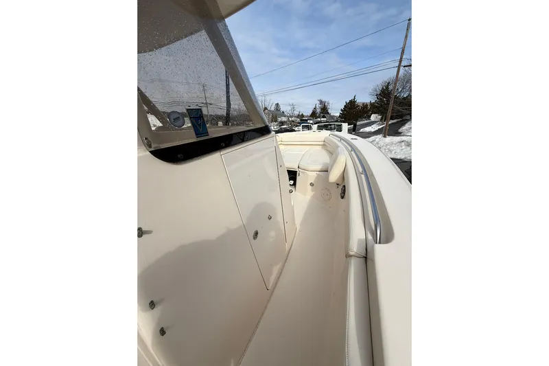  Yacht Photos Pics 2019 Grady-White Canyon 306 boat interior with windshield and seating, under clear sky.