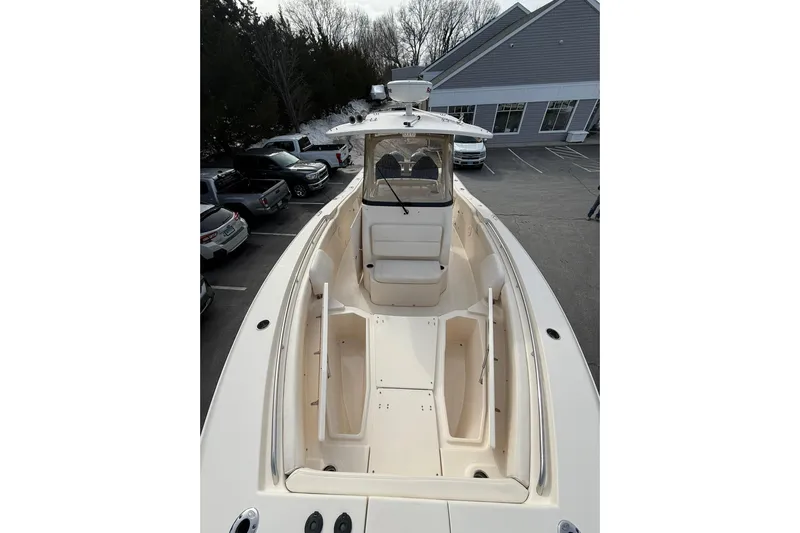  Yacht Photos Pics 2019 Grady-White Canyon 306 boat in parking lot, showcasing spacious deck and seating.