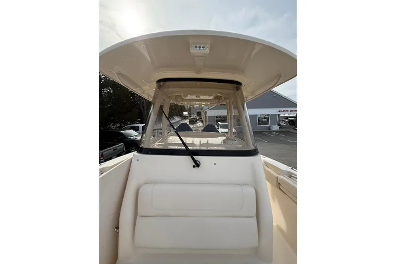  Yacht Photos Pics 2019 Grady-White Canyon 306 boat with T-top and windshield, parked outdoors.