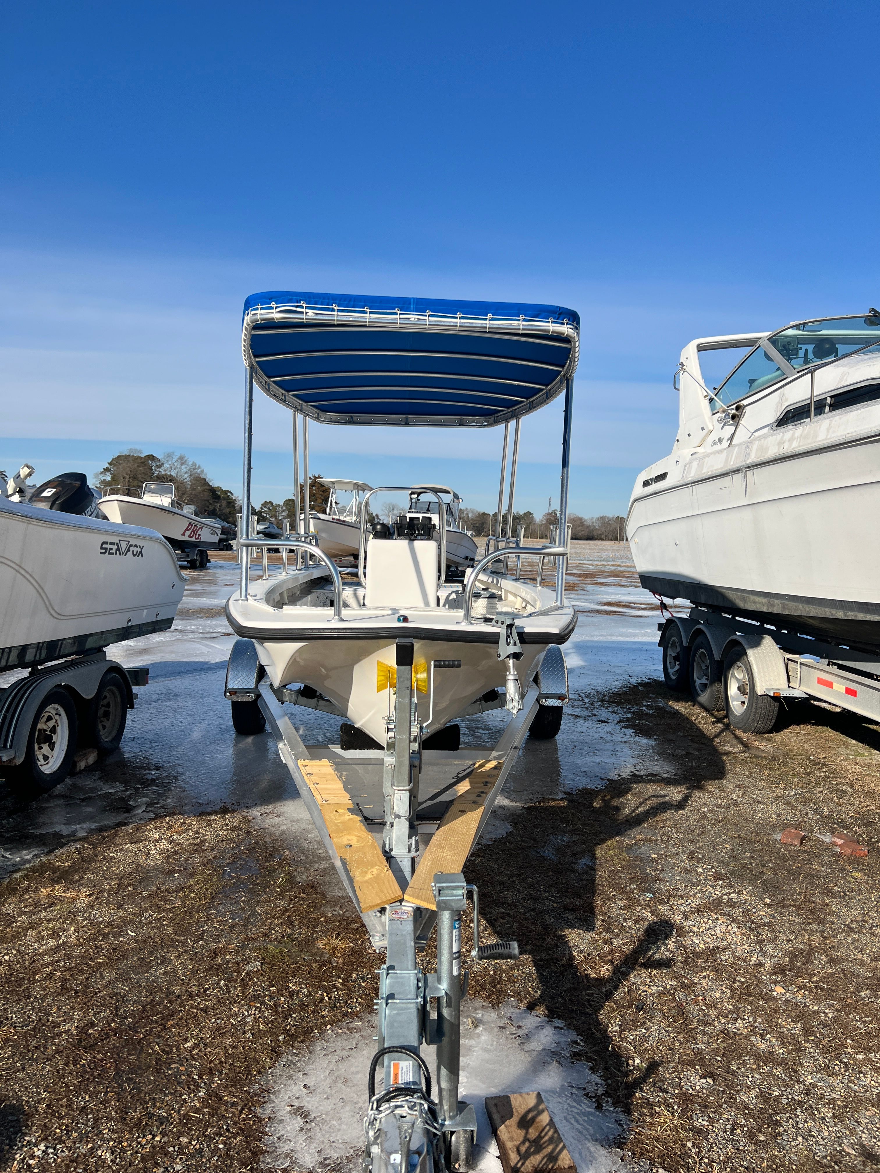 2021 C-Hawk 16 Tiller boat on trailer outdoors.