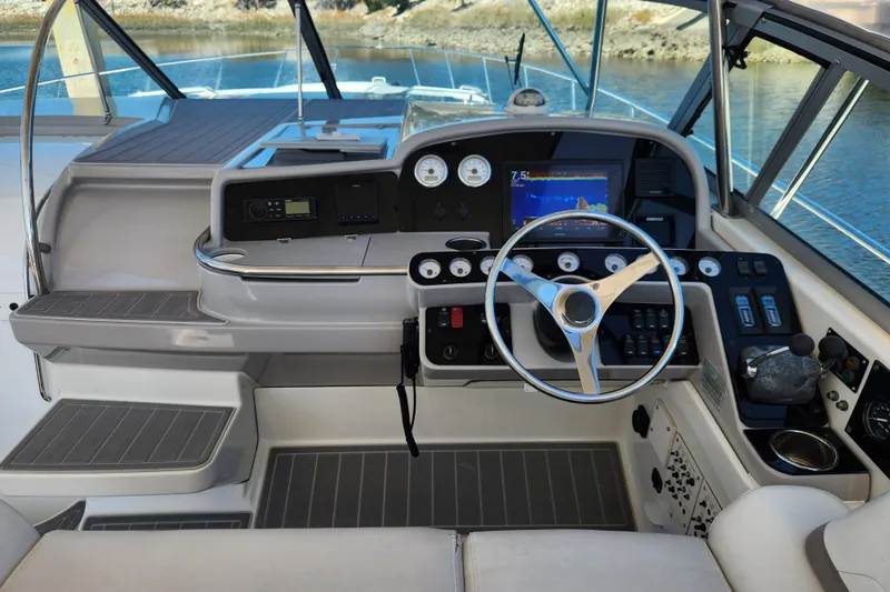 H Yacht Photos Pics Cockpit of 2000 Formula 41 Performance Cruiser with steering wheel and navigation instruments.