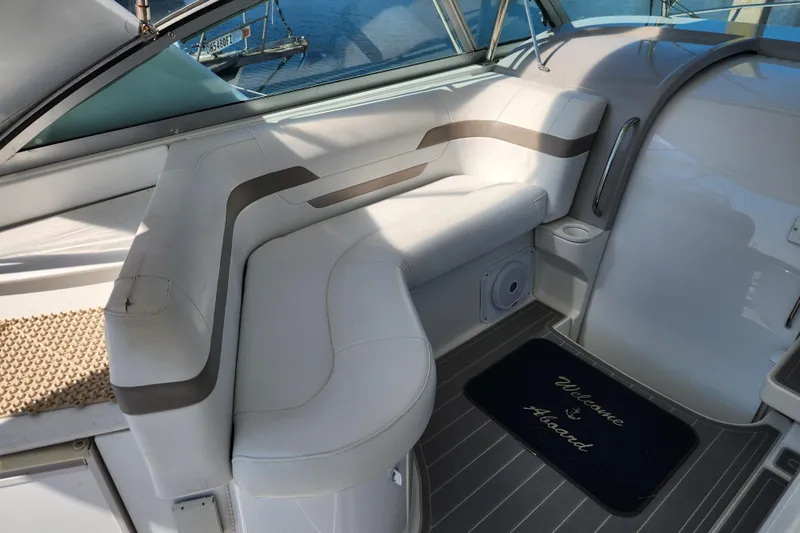 H Yacht Photos Pics Interior of 2000 Formula 41 Performance Cruiser with white seating and "Welcome Aboard" mat.