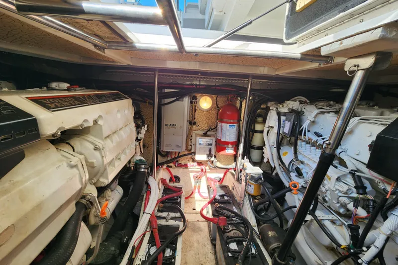 H Yacht Photos Pics Engine room of a 2000 Formula 41 Performance Cruiser with visible machinery and fire extinguisher.