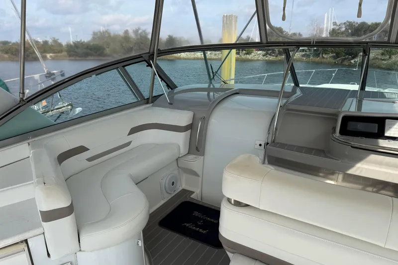 H Yacht Photos Pics Interior of 2000 Formula 41 Performance Cruiser with seating and helm, docked by water.