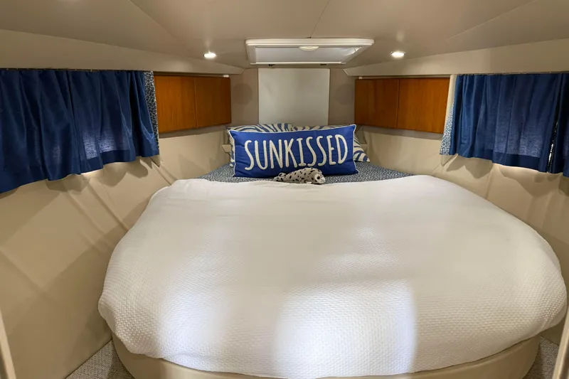 H Yacht Photos Pics Cozy cabin interior of 2000 Formula 41 Performance Cruiser with "Sunkissed" pillow and blue curtains.