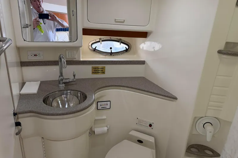 H Yacht Photos Pics Bathroom interior of 2000 Formula 41 Performance Cruiser with sink, mirror, and porthole.