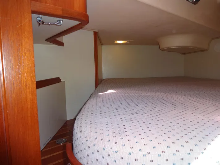 Don't Blink Yacht Photos Pics Interior cabin of 2006 Island Packet 440 sailboat with wooden accents and cozy bed.