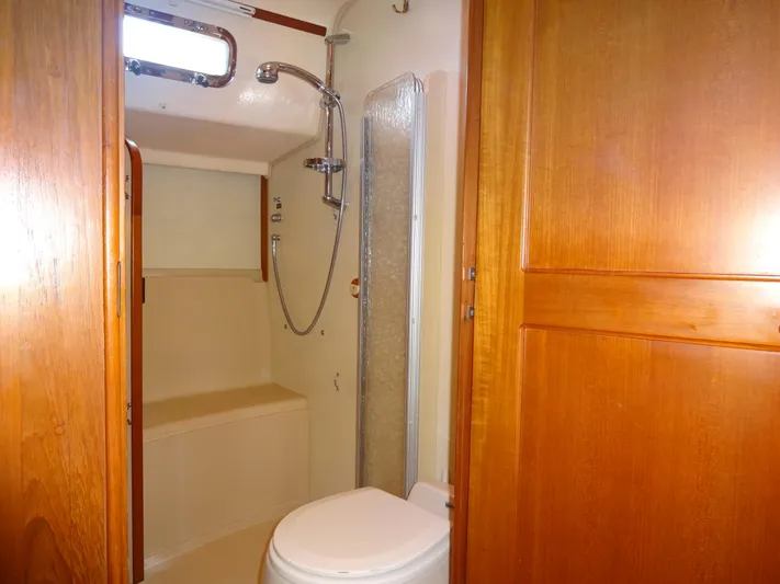 Don't Blink Yacht Photos Pics Bathroom interior of 2006 Island Packet 440 yacht with shower and wooden cabinetry.