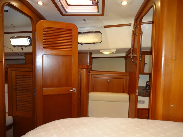 Don't Blink Yacht Photos Pics Interior of 2006 Island Packet 440 yacht, featuring wooden cabinetry and cozy design.