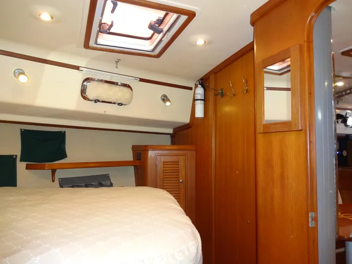 Don't Blink Yacht Photos Pics Interior of 2006 Island Packet 440 yacht with wooden cabinetry and cozy sleeping area.