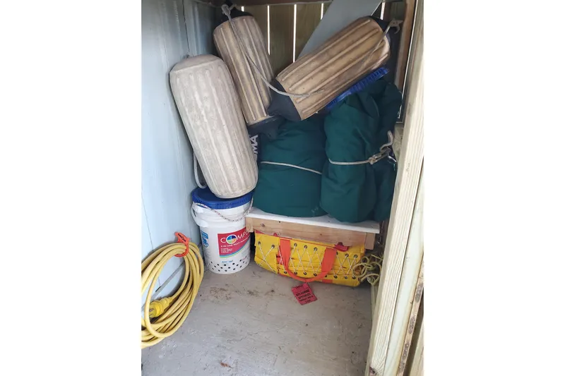 Don't Blink Yacht Photos Pics Storage compartment with boat fenders, buckets, and ropes on a 2006 Island Packet 440.