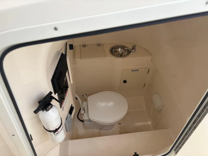  Yacht Photos Pics 2014 Pursuit C 280 Center Console boat interior with toilet and sink.