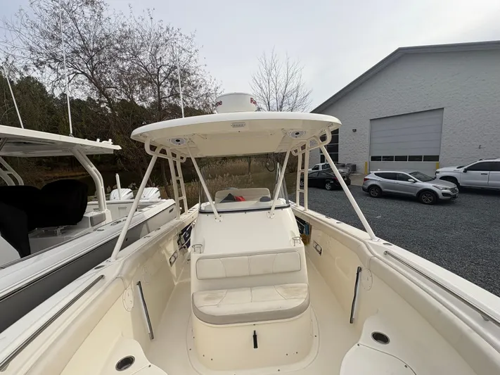  Yacht Photos Pics 2014 Pursuit C 280 Center Console boat with seating and canopy, parked outdoors.