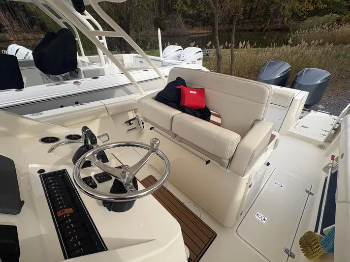  Yacht Photos Pics 2014 Pursuit C 280 Center Console boat interior with steering wheel and seating area.