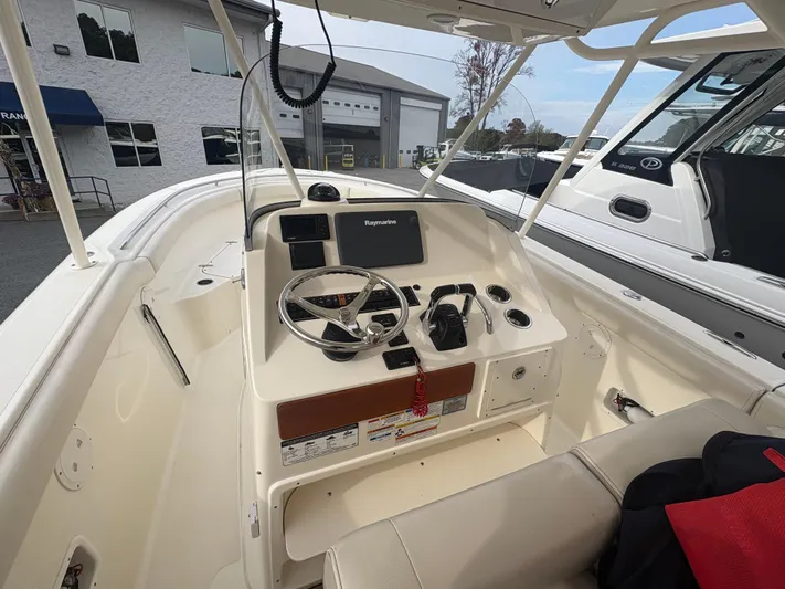  Yacht Photos Pics 2014 Pursuit C 280 Center Console boat interior with steering wheel and navigation equipment.