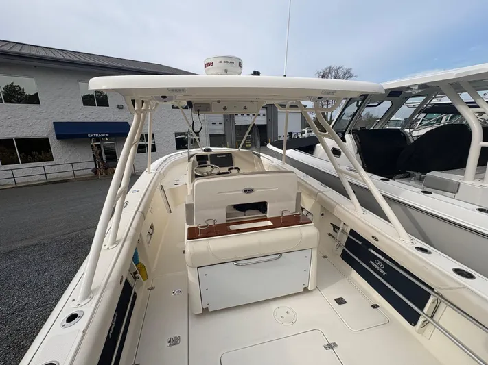  Yacht Photos Pics 2014 Pursuit C 280 Center Console boat, docked, showcasing spacious deck and seating area.