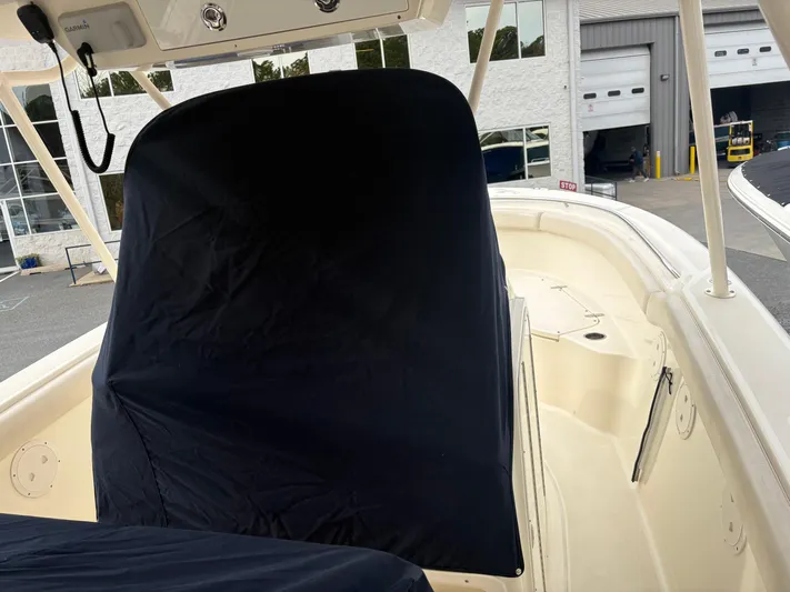  Yacht Photos Pics 2014 Pursuit C 280 Center Console boat with covered helm, docked near a building.