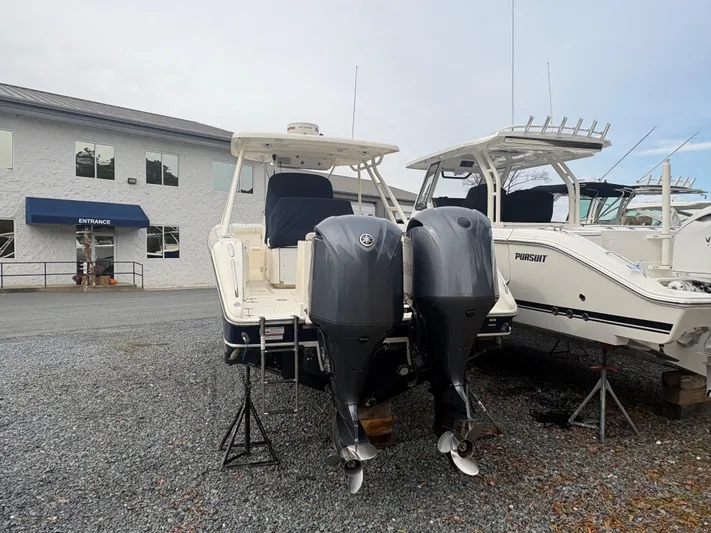  Yacht Photos Pics 2014 Pursuit C 280 Center Console boat with dual outboard motors in a marina.