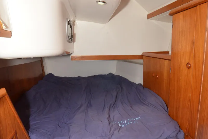 Misty Blue Yonder Yacht Photos Pics Cozy cabin interior of 1995 Jeanneau Sun Odyssey 45.1 sailboat with wooden cabinetry.