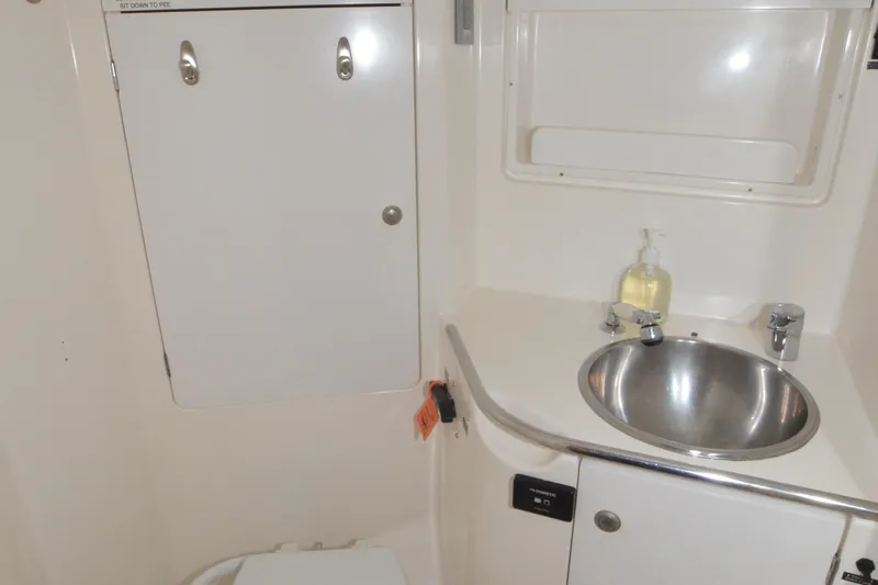 Misty Blue Yonder Yacht Photos Pics Bathroom interior of 1995 Jeanneau Sun Odyssey 45.1 yacht with sink and storage.