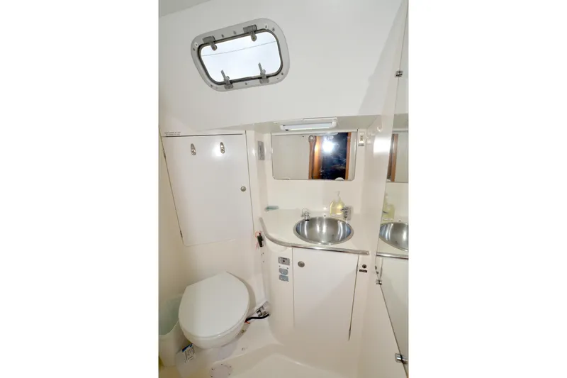 Misty Blue Yonder Yacht Photos Pics Bathroom interior of 1995 Jeanneau Sun Odyssey 45.1 yacht, featuring sink and toilet.