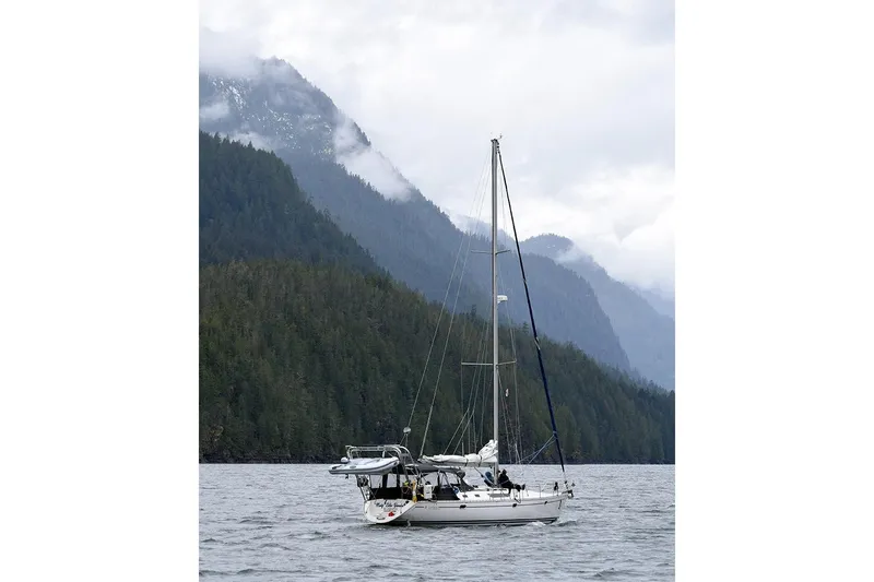 Misty Blue Yonder Yacht Photos Pics Sailboat Jeanneau Sun Odyssey 45.1, 1995, cruising near misty forested mountains.