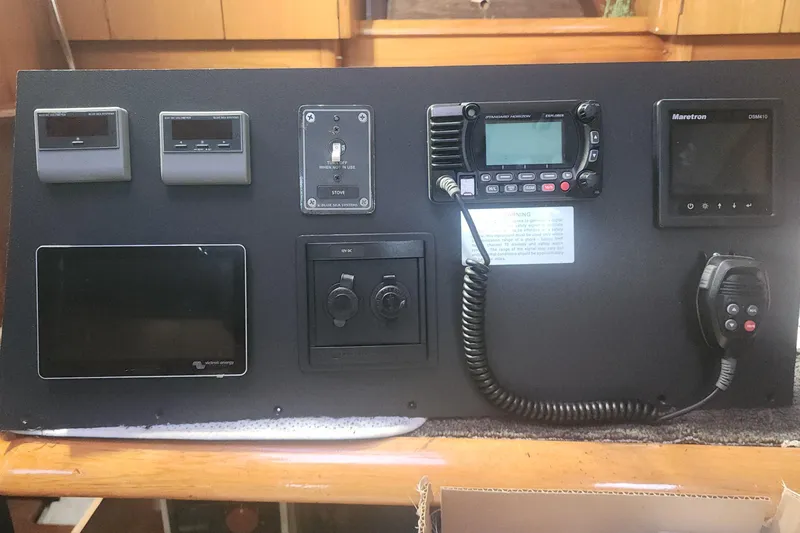 Misty Blue Yonder Yacht Photos Pics Control panel of a 1995 Jeanneau Sun Odyssey 45.1 sailboat with navigation equipment.