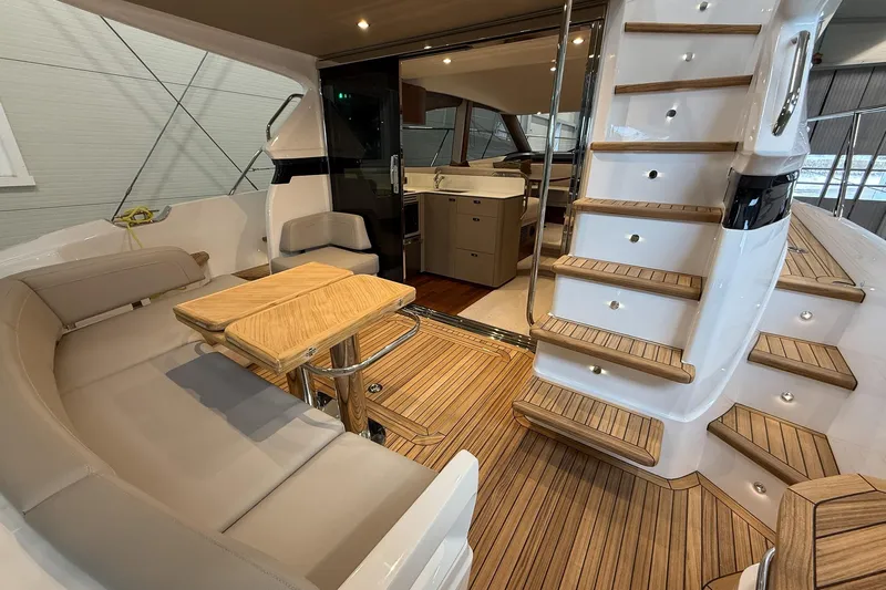 F45095 Yacht Photos Pics Luxurious 2023 Princess F45 yacht interior with elegant seating and wooden staircase.