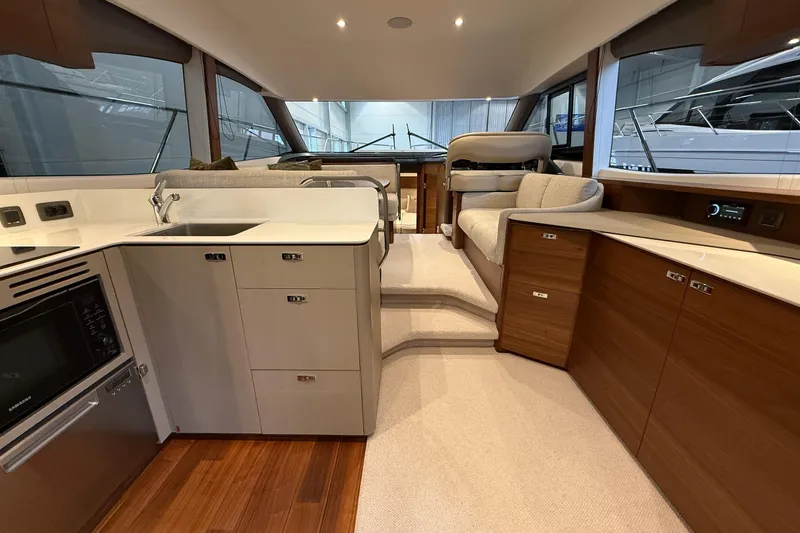 F45095 Yacht Photos Pics Luxurious interior of 2023 Princess F45 yacht featuring modern kitchen and seating area.