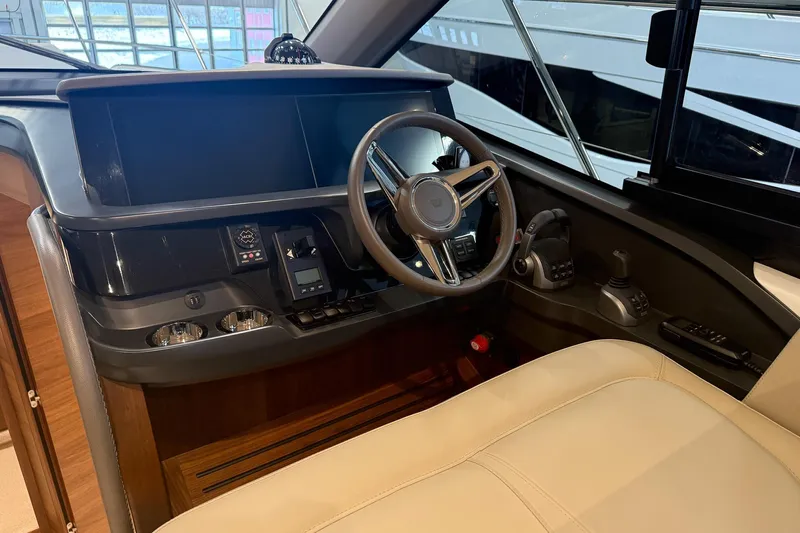 F45095 Yacht Photos Pics Interior helm of 2023 Princess F45 yacht with modern controls and steering wheel.