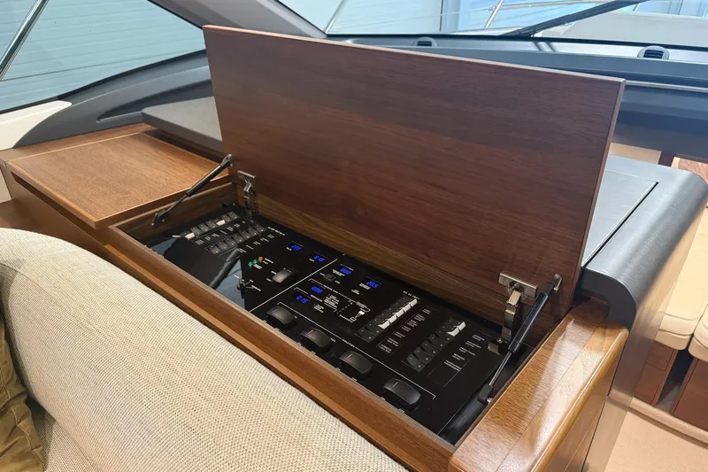 F45095 Yacht Photos Pics 2023 Princess F45 yacht control panel with wooden cover, showcasing modern design.