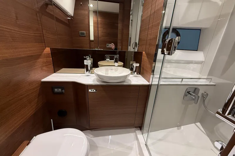 F45095 Yacht Photos Pics Luxurious bathroom in 2023 Princess F45 yacht with modern fixtures and wooden accents.