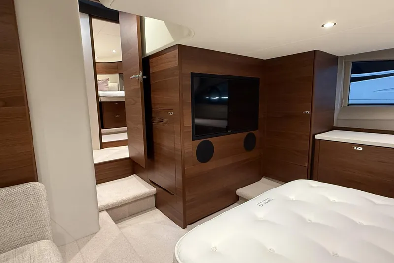 F45095 Yacht Photos Pics Luxurious interior of 2023 Princess F45 yacht with modern wood paneling and flat-screen TV.