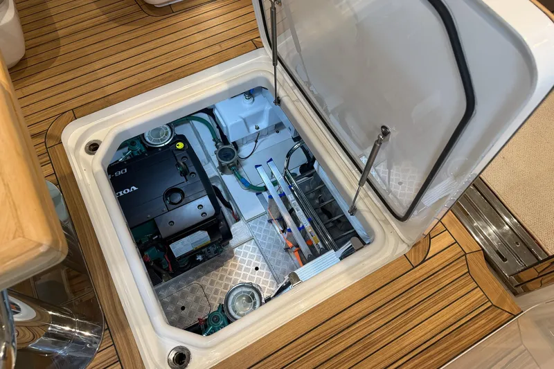 F45095 Yacht Photos Pics Engine compartment of 2023 Princess F45 yacht, featuring Volvo Penta engine, on teak flooring.