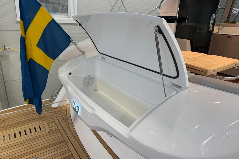 F45095 Yacht Photos Pics 2023 Princess F45 yacht with open storage compartment and Swedish flag on deck.