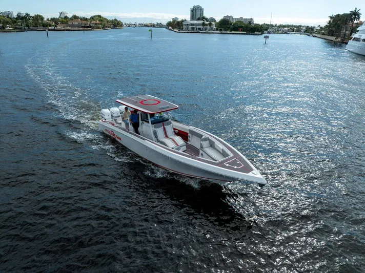 Havana Club Yacht Photos Pics 2023 Fountain 38 SC boat cruising on a sunny waterway.