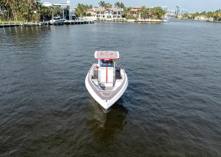 Havana Club Yacht Photos Pics 2023 Fountain 38 SC boat cruising on a scenic waterway with luxury homes in the background.