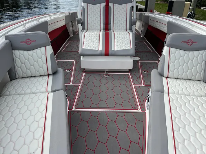 Havana Club Yacht Photos Pics 2023 Fountain 38 SC boat interior with stylish seating and hexagonal pattern flooring.