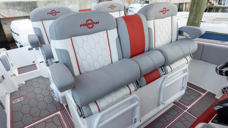 Havana Club Yacht Photos Pics 2023 Fountain 38 SC boat seats with gray and red accents, featuring hexagonal patterns.