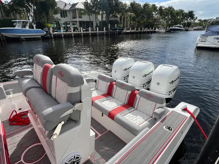Havana Club Yacht Photos Pics 2023 Fountain 38 SC boat with triple engines docked by waterfront homes.