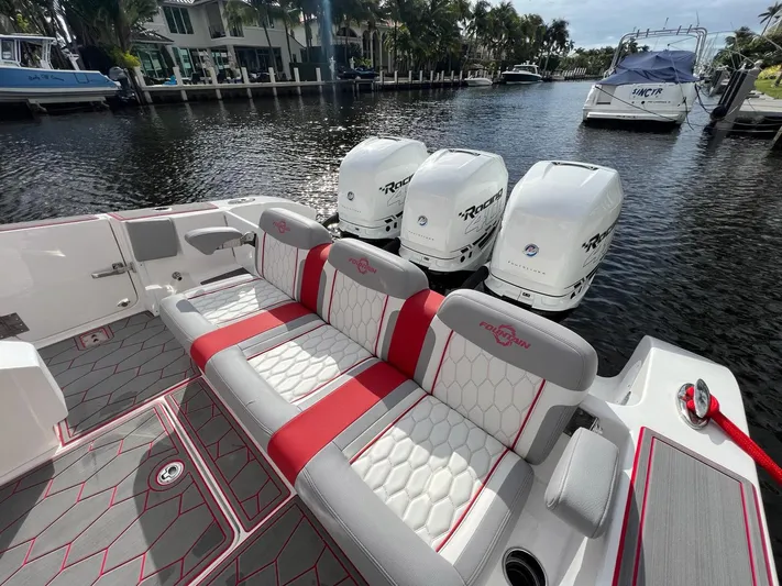 Havana Club Yacht Photos Pics 2023 Fountain 38 SC boat with triple engines and stylish seating on a calm waterway.