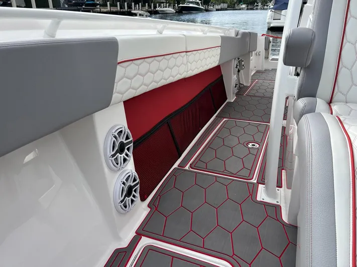 Havana Club Yacht Photos Pics 2023 Fountain 38 SC boat interior with hexagonal pattern flooring and speakers.