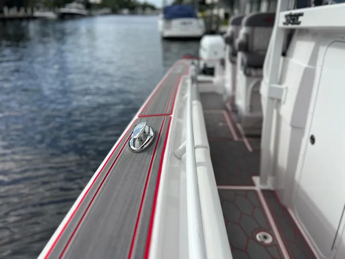 Havana Club Yacht Photos Pics 2023 Fountain 38 SC boat deck with sleek design and red accents by the water.