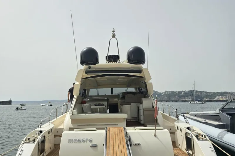  Yacht Photos Pics Cayman Yachts 55-58 Walkaround HT 2003, docked with scenic waterfront view.