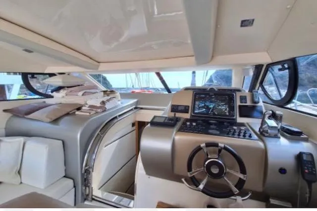  Yacht Photos Pics Interior view of 2003 Cayman Yachts 55-58 Walkaround HT, featuring helm and navigation equipment.