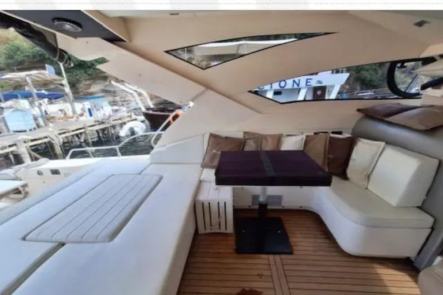  Yacht Photos Pics Luxurious 2003 Cayman Yachts 55-58 Walkaround HT interior with elegant seating and wooden flooring.