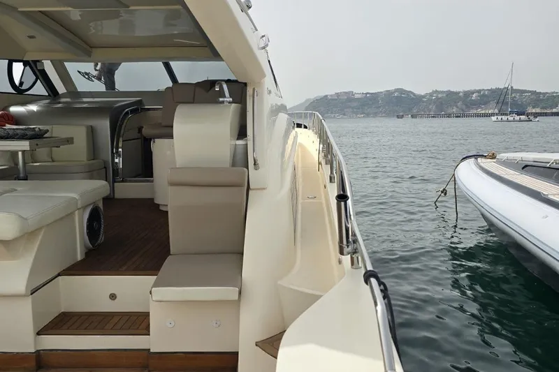  Yacht Photos Pics Luxurious 2003 Cayman Yachts 55-58 Walkaround HT docked, showcasing elegant interior and scenic waterfront.