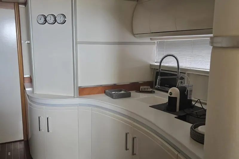  Yacht Photos Pics Luxurious kitchen interior of 2003 Cayman Yachts 55-58 Walkaround HT with modern appliances.